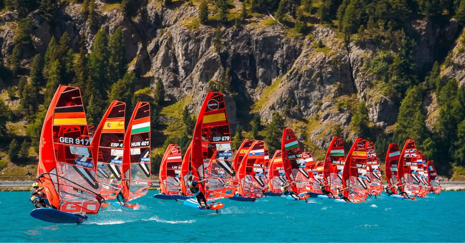 High-performance red and yellow iQFOiL windsurfing board with black accents