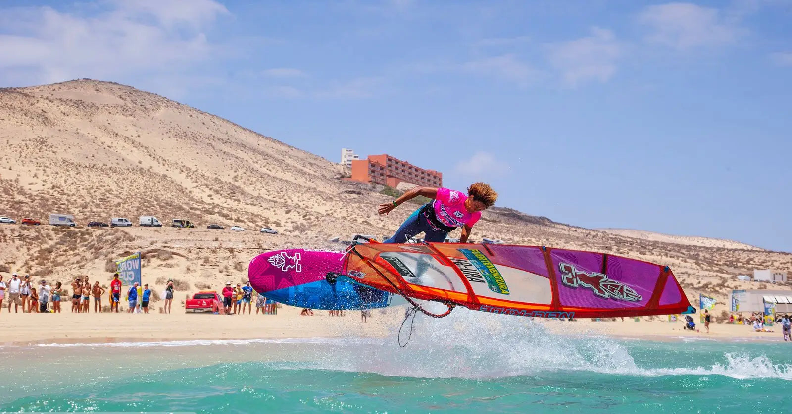 Purple pink fiberglass surfboard with green leaf design in PWA article