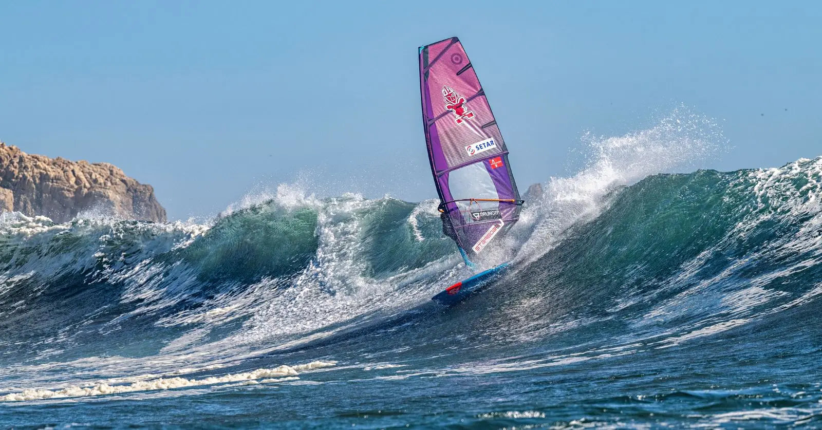 Purple pink windsurfing sail with white design in Chile World Cup article