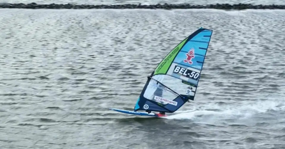 Young Starboard rider John Johns Bel 50 windsurfing board with blue and white sail