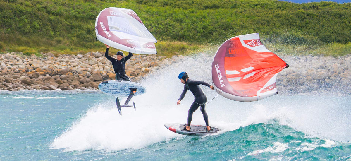 Red hydrofoil board with black fins and white sail for wing foiling
