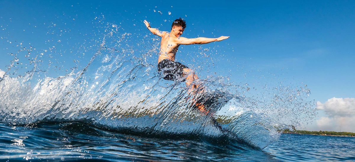 White and black Pump Foil hydrofoil board with fins for high-performance surfing