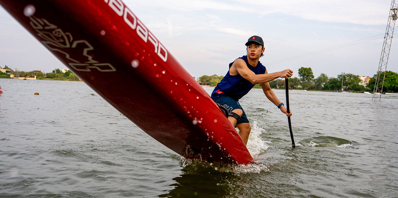 Race paddleboard with teal orange accents black leash standup logo