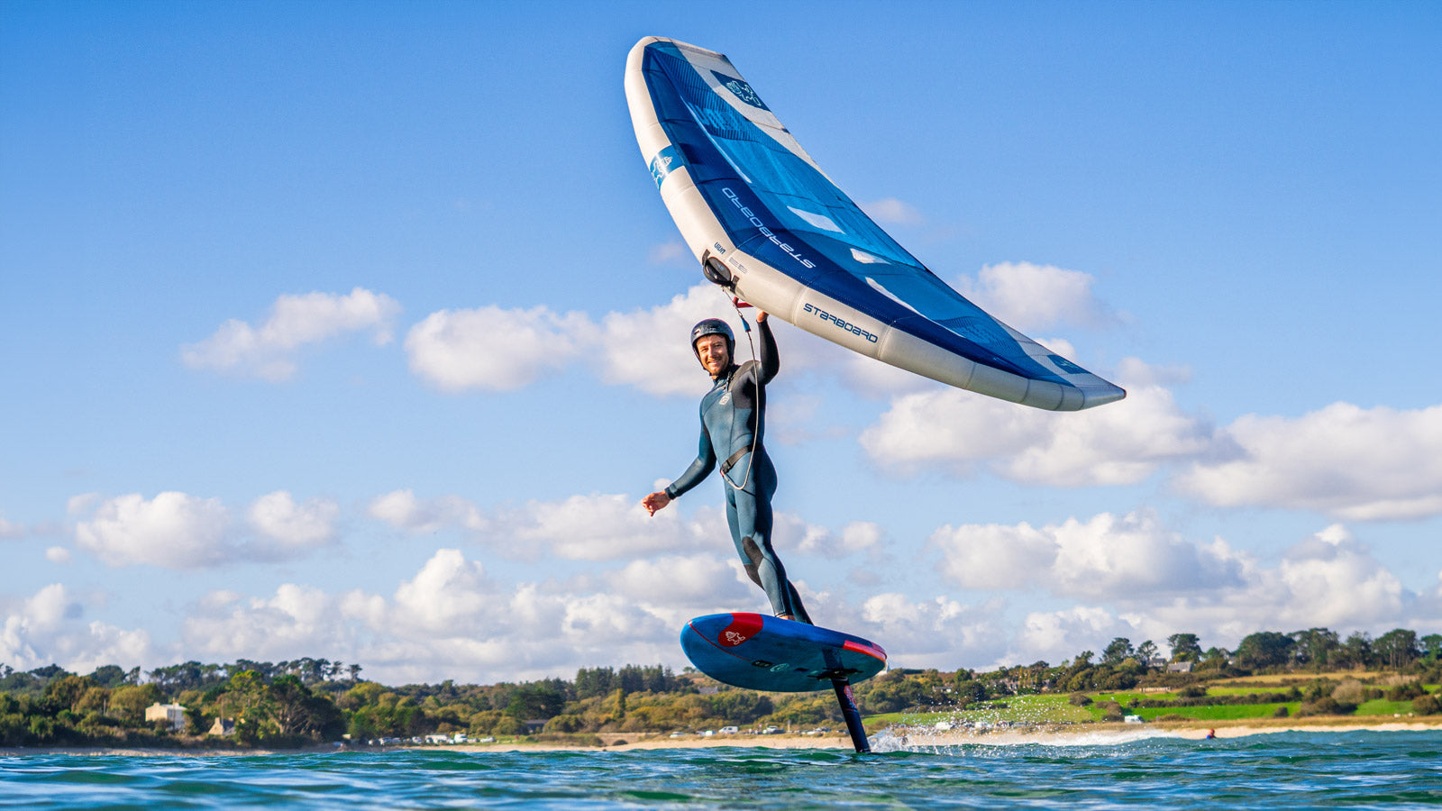 Sleek white and black hydrofoil surfboard with carbon fiber construction in Foilboards collection