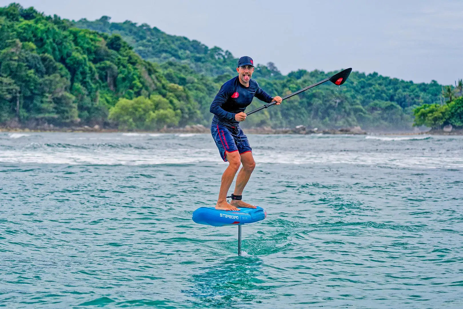 Blue and white Ace Air Foil inflatable hydrofoil board with black paddle