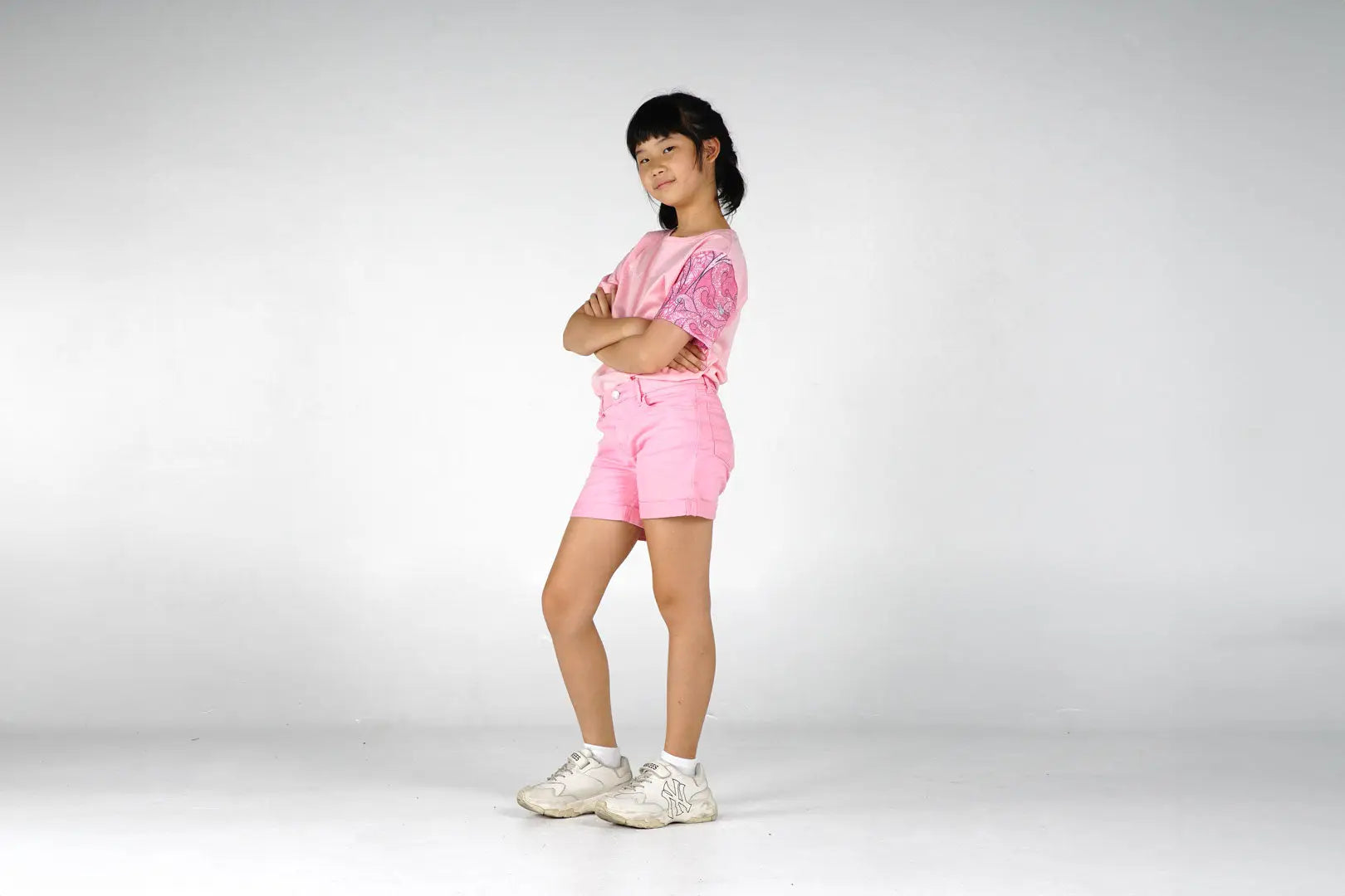 Pink tie-dye t-shirt with shorts and white sneakers for girls