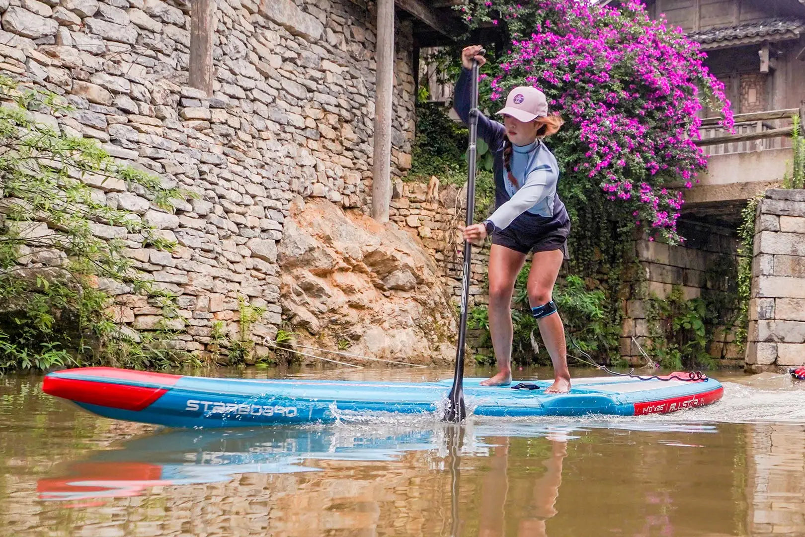 Red and blue stand-up paddleboard with standupboard text and black grip tape
