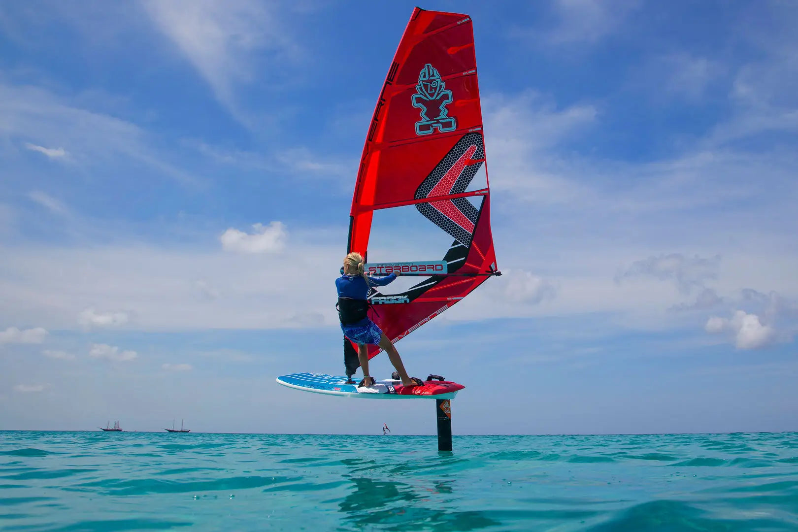 Red sailboard with blue and white hydrofoil design in Entry-Level Windfoil