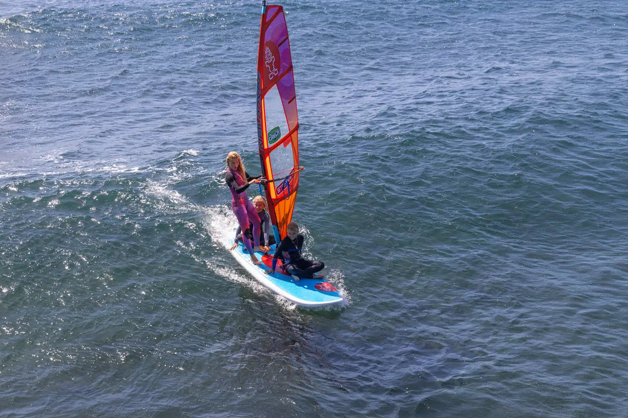 Entry-level blue windsurfing board with purple orange sail