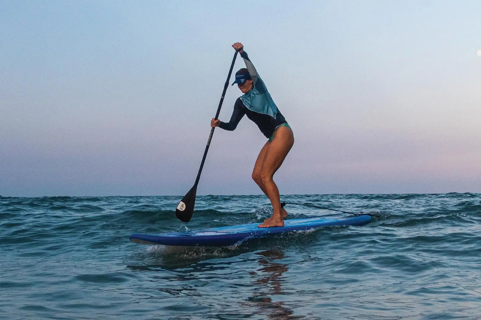 Blue stand-up paddleboard with white and black design in GO Paddleboards