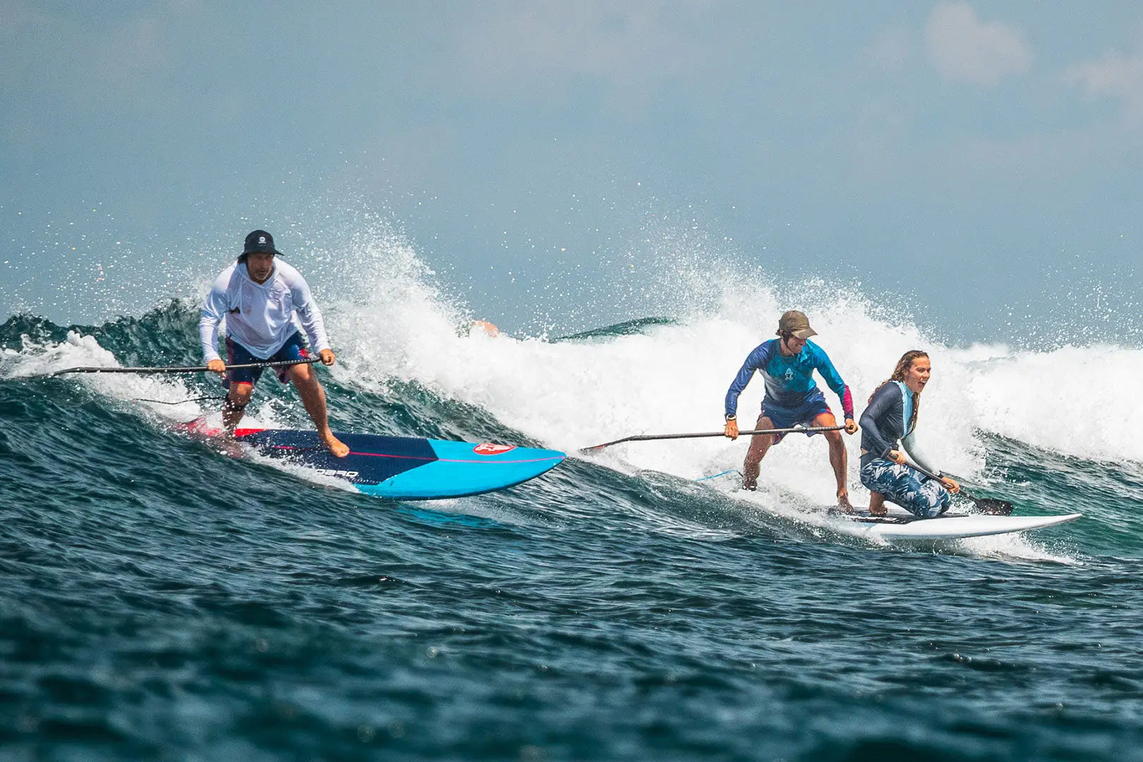 Blue stand-up paddleboard with white and red accents in Hard Paddleboards