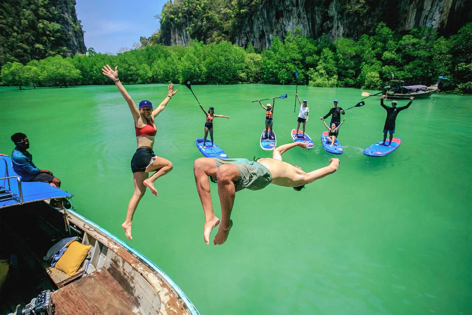 Green foam paddleboard with blue accents and white logo