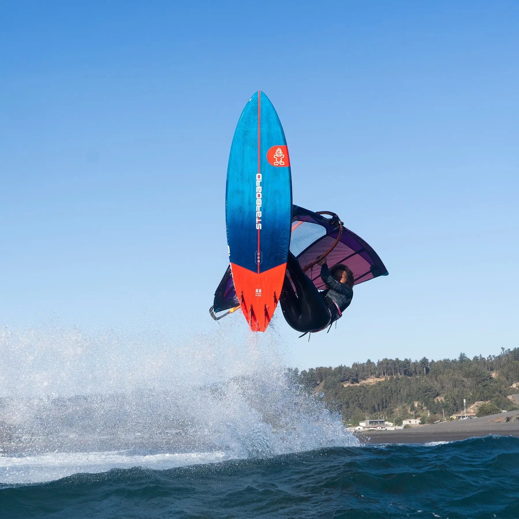 Blue and orange freestyle surfboard with red fins from Hyper Windsurf Boards