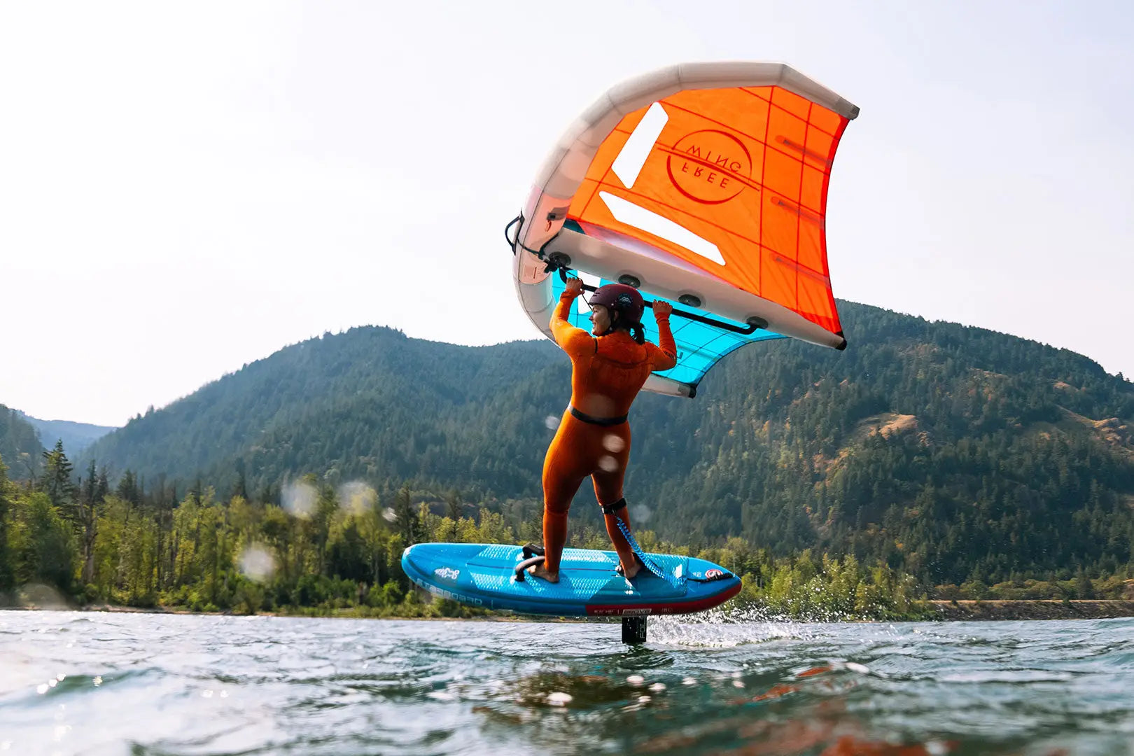 Orange and blue inflatable foilboard with sail
