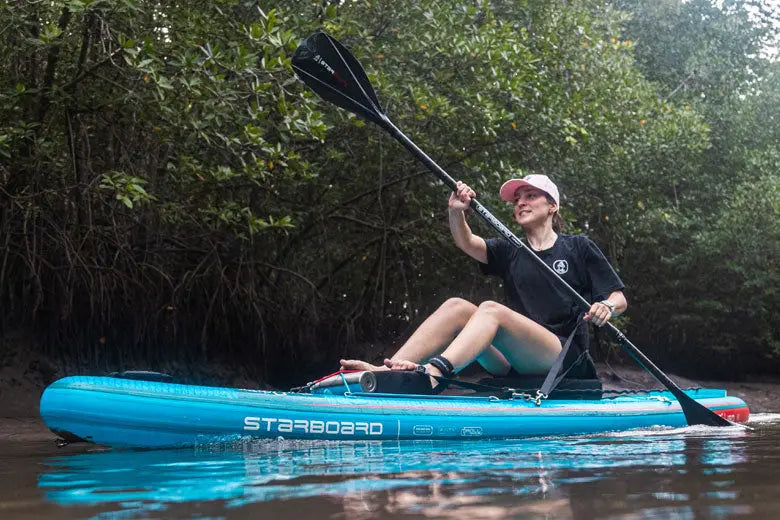 Starboard inflatable paddle board in blue and white with black seat cushion