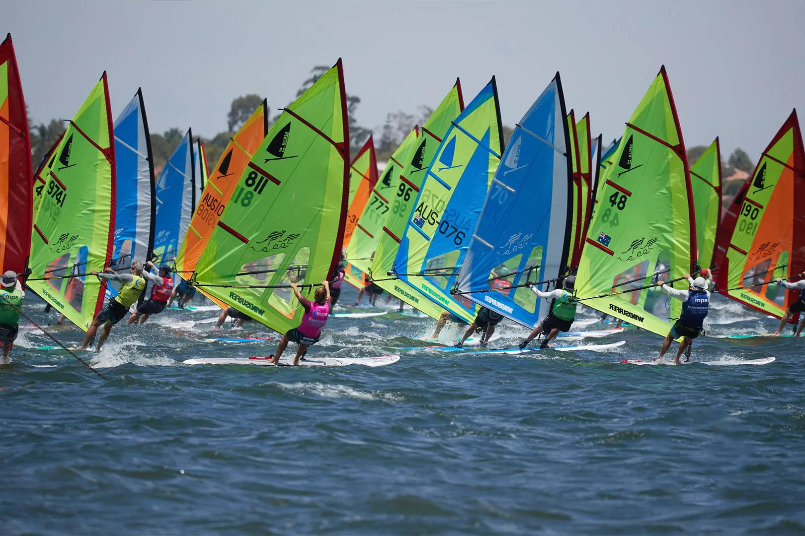 Longboard windsurfing board with colorful sails and sleek design