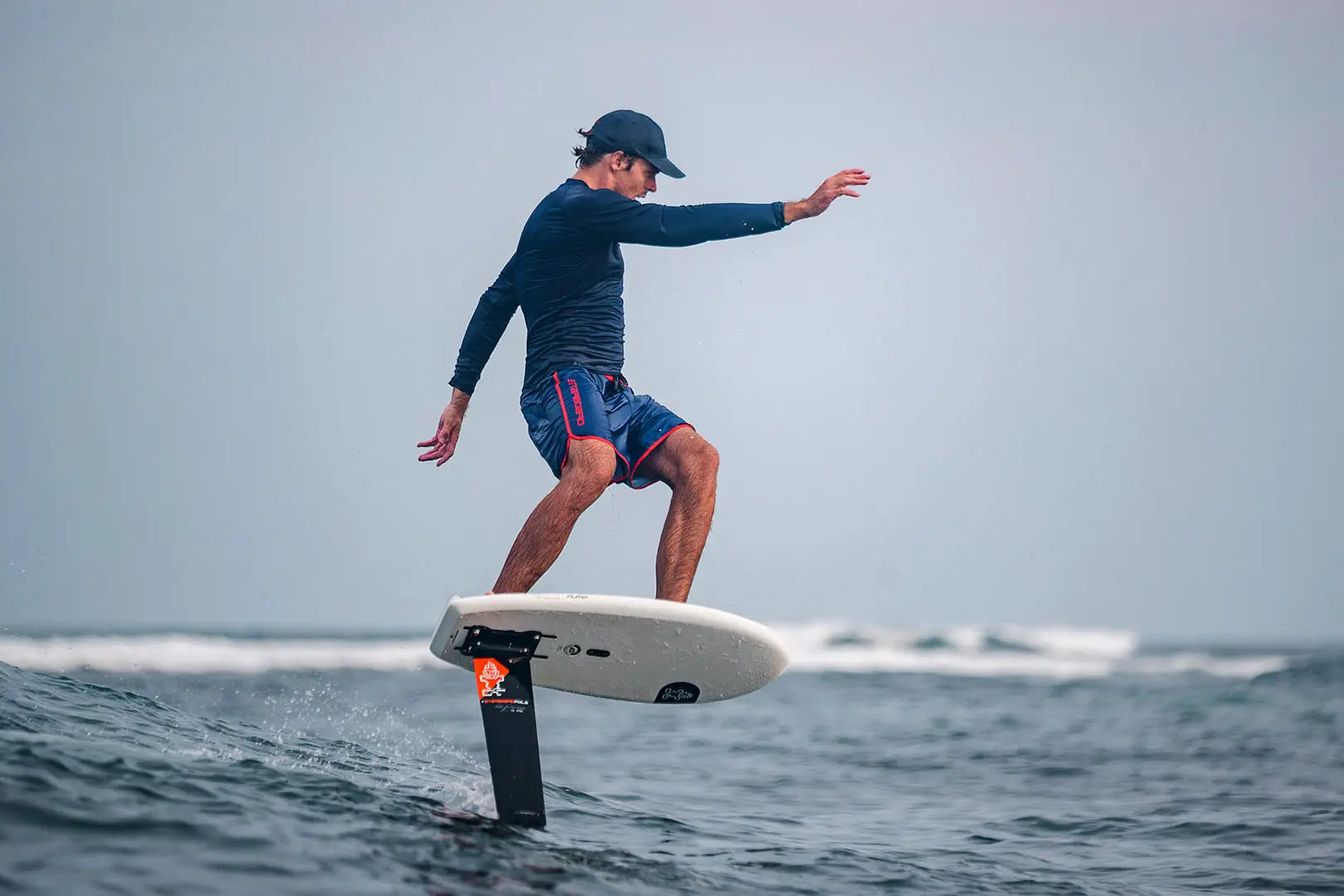 White and black Pump Foil hydrofoil board with fins for high-performance surfing