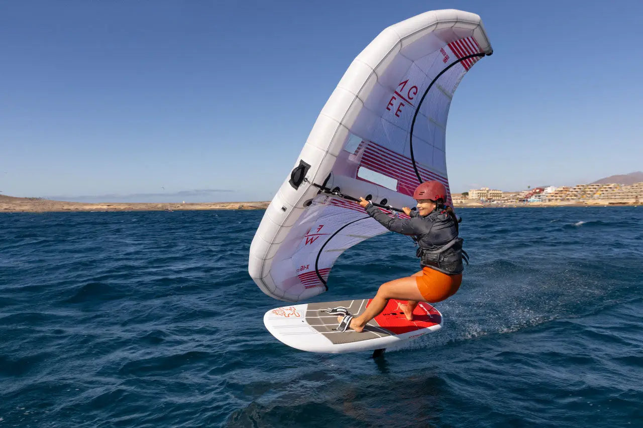 Red and white kiteboarding board with large sail in Race Wingfoil collection