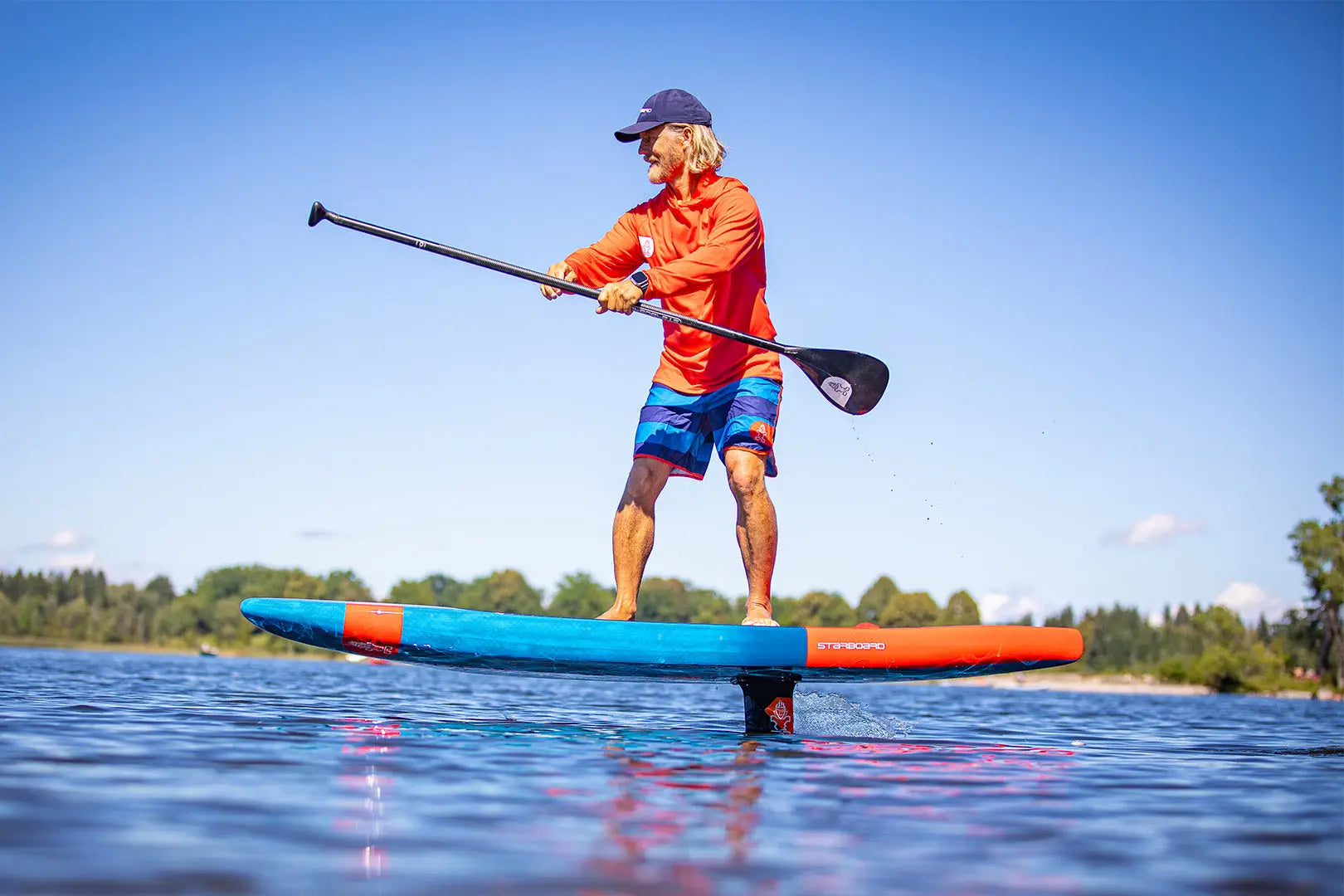 SUP foiling paddleboard with blue orange deck black handlebars red leash
