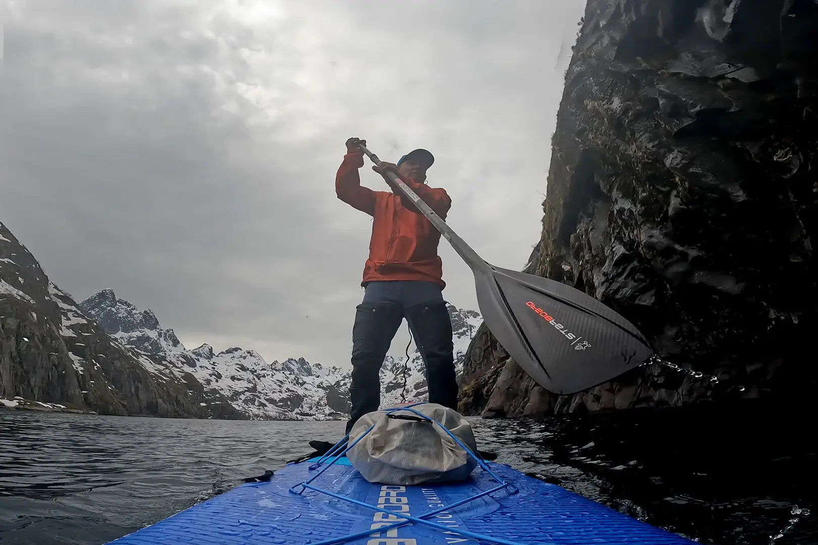 Blue 10-foot SUP touring paddleboard with black and red design