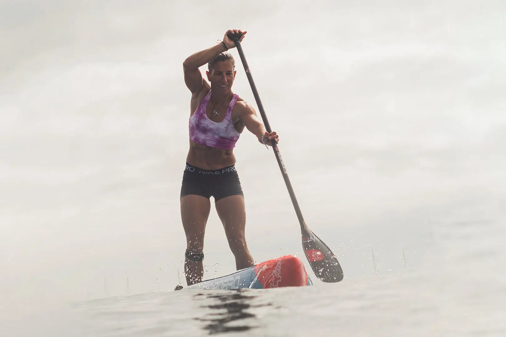 Red and white Velocity SUP Paddle stand-up paddle board with black grip tape