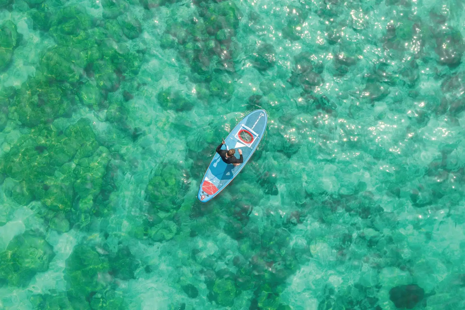 Transparent Vision kayak with blue accents and red seat cushion