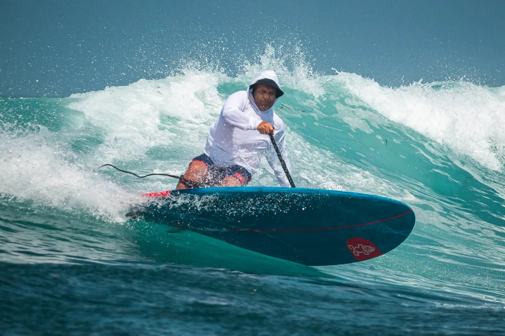 Blue Whopper stand-up paddleboard with red fins and white logo