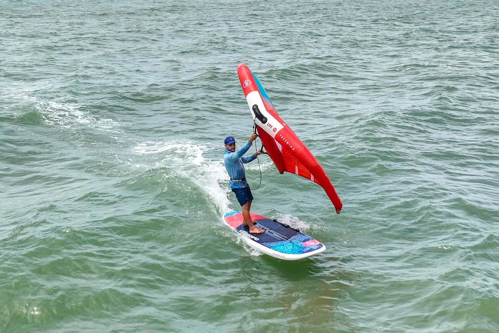 Red and white Wingboard 4-in-1 Crossover windsurfing sail with blue trim