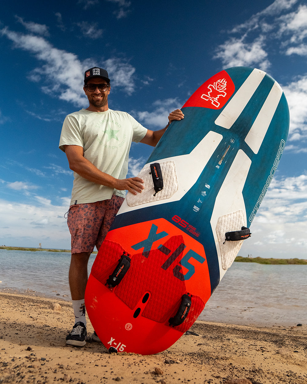 Red and teal X-15 windfoil board with black fins