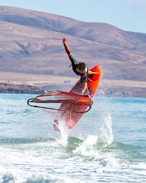 IGnite Windsurf Board: red carbon fiber with black and orange accents