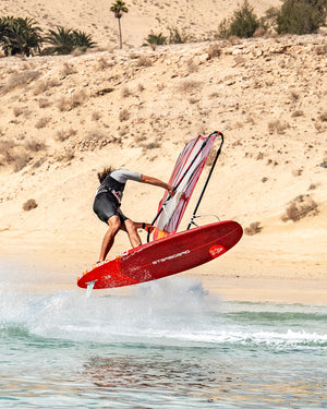 Red iGnite Windsurf Board: hydrofoil with black fins and white sail