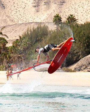 IGnite Windsurf Board: red carbon fiber with black and white design