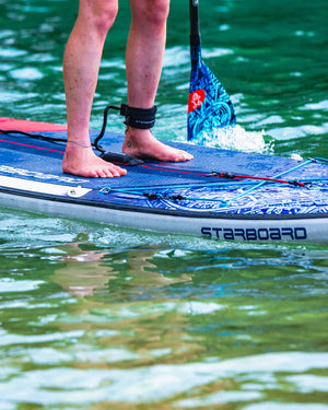 Blue and white Enduro Tiki Tech Lite inflatable paddle board with black leash
