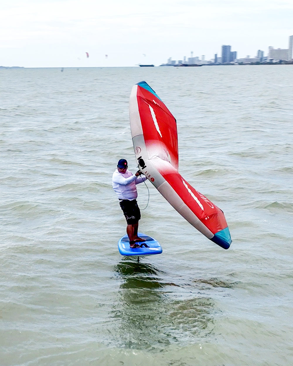 Red and white Above Foilboard inflatable windsurfing sail with blue trim