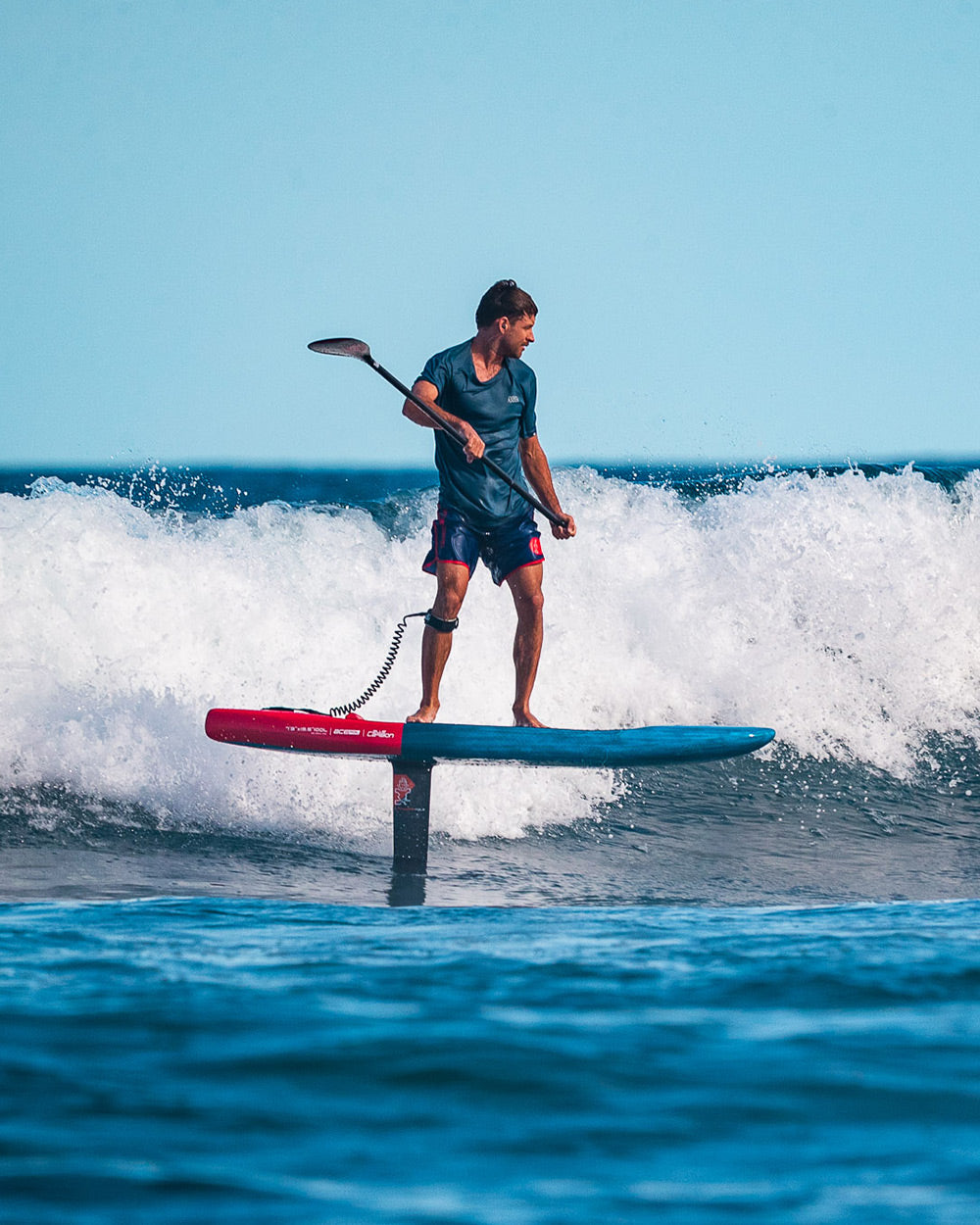 Ace Foil red and blue hydrofoil board with black paddle