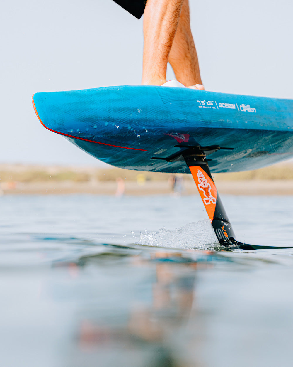 Ace Foil Lightning Foilboard: blue hydrofoil with orange fins for downwind performance