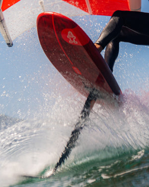 Red iGnite Wing Foilboard: hydrofoil with black fins and white logo