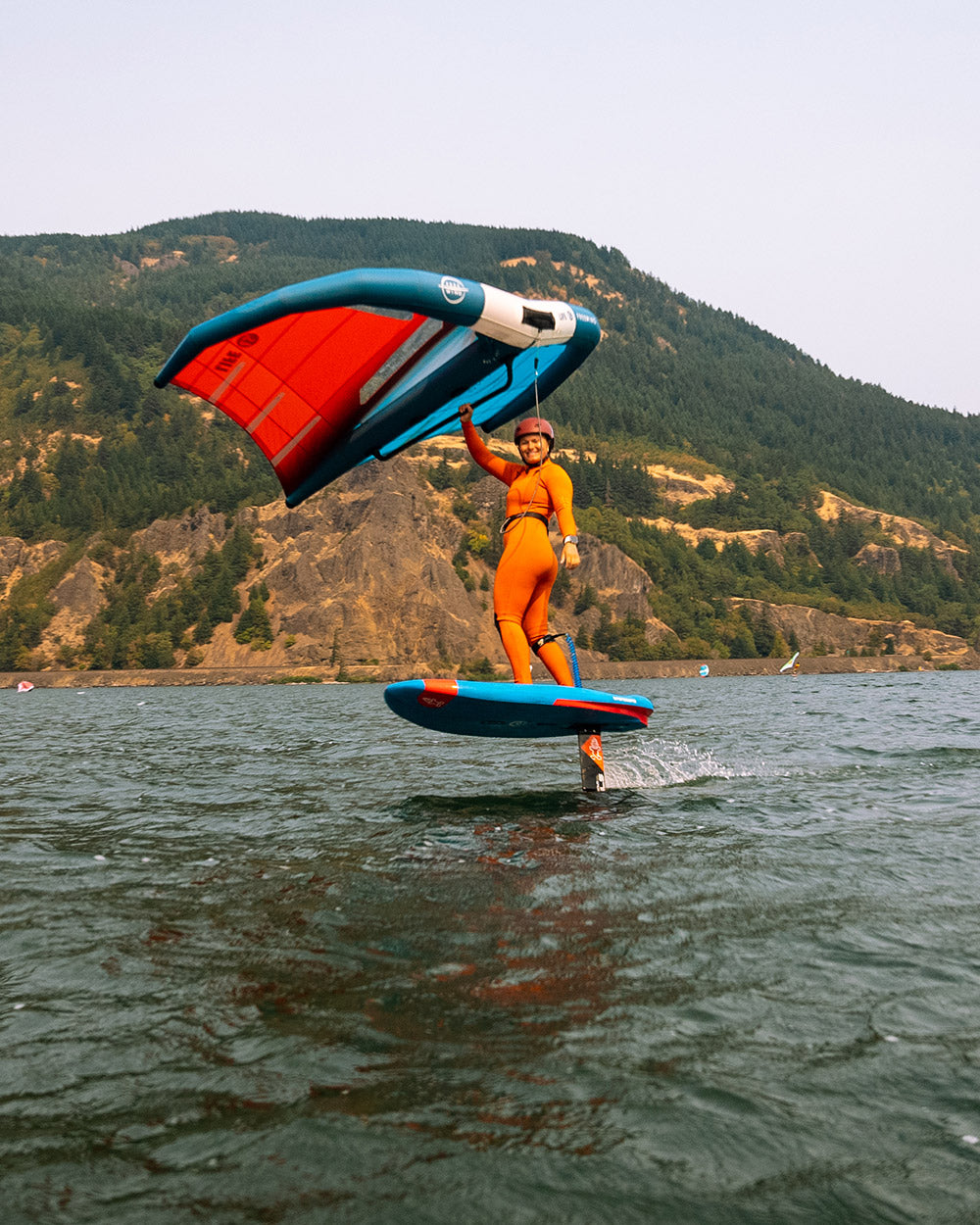 High-performance blue and red kiteboarding wing with white stripe on 2025 Wingboard Foil Board