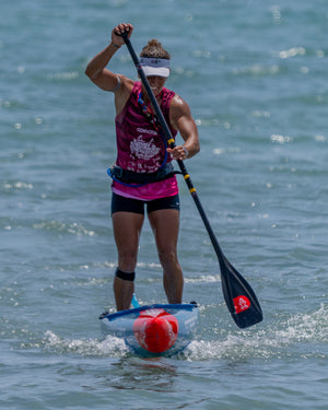 Transparent Lima Prepreg Carbon Paddle with red buoyancy aid and black paddle in kayak