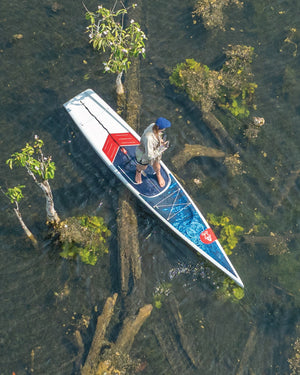 Blue and white wooden canoe with red accents for outdoor exploration