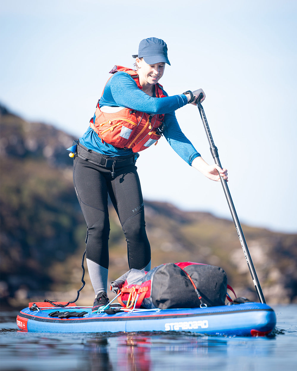 Blue and red Touring Inflatable Paddleboard with black accents for adventure