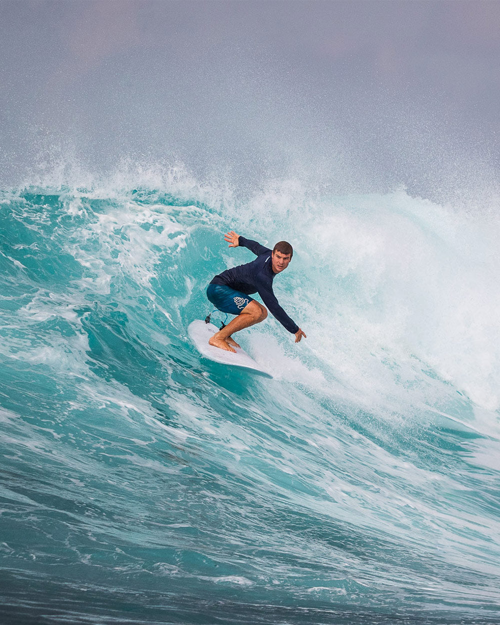 Blue and white longboard surf with black leash