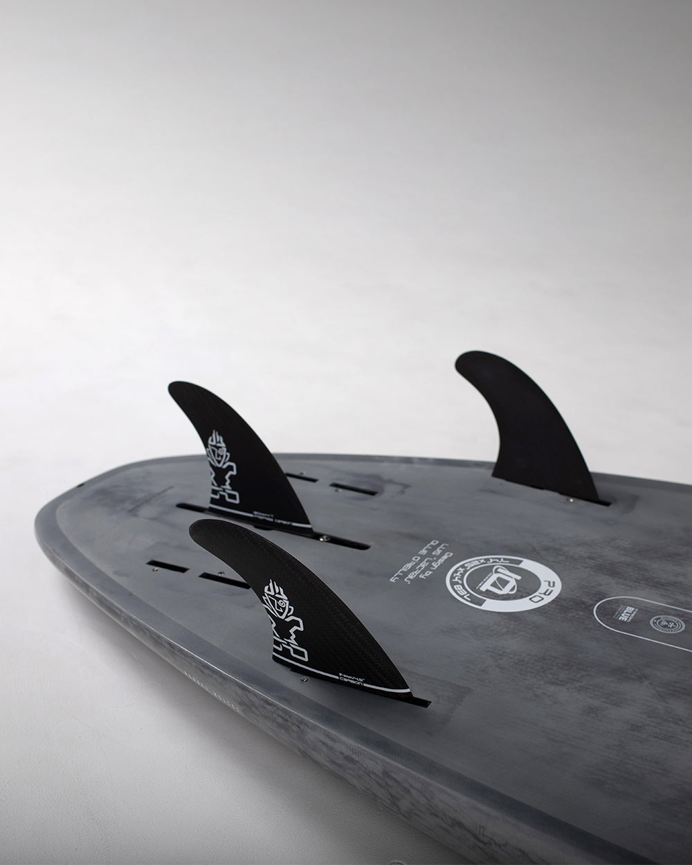 Black Pro Paddleboard surfboard with fins and logo design