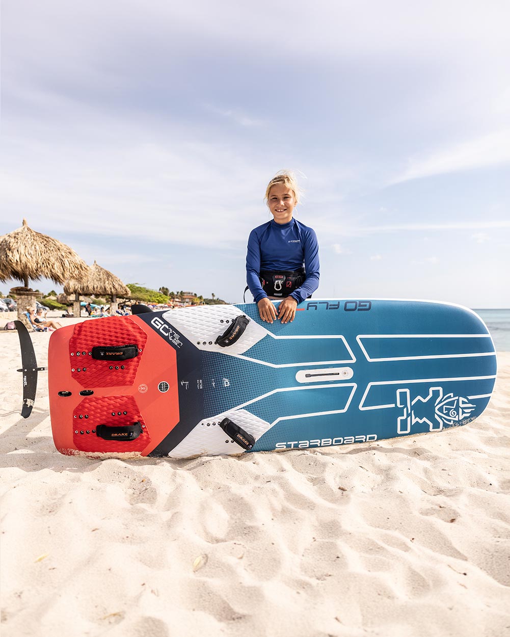 Blue and white GO-Fly Windfoil Board with red fins