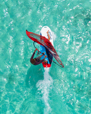 Red and white 2024 GO Windsurfer Board with blue fins for windsurfing