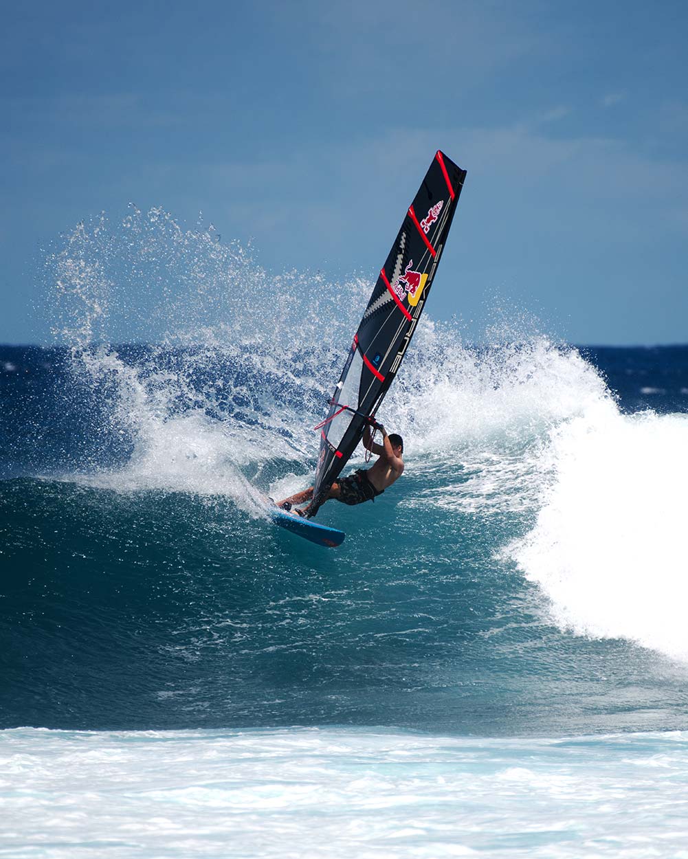 Red and black windsurfing sail with white logo on 2025 Hyper Windsurf Board