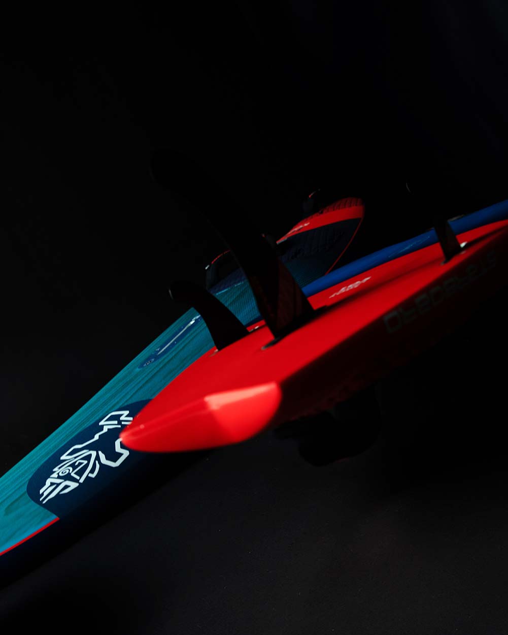 Red and blue toy submarine with white logo on 2025 Kode Windsurf Board