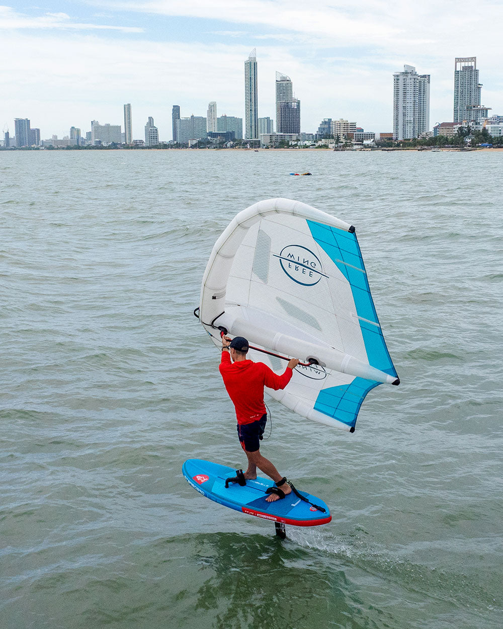 Blue and red Above Air Foil inflatable foilboard with white sail